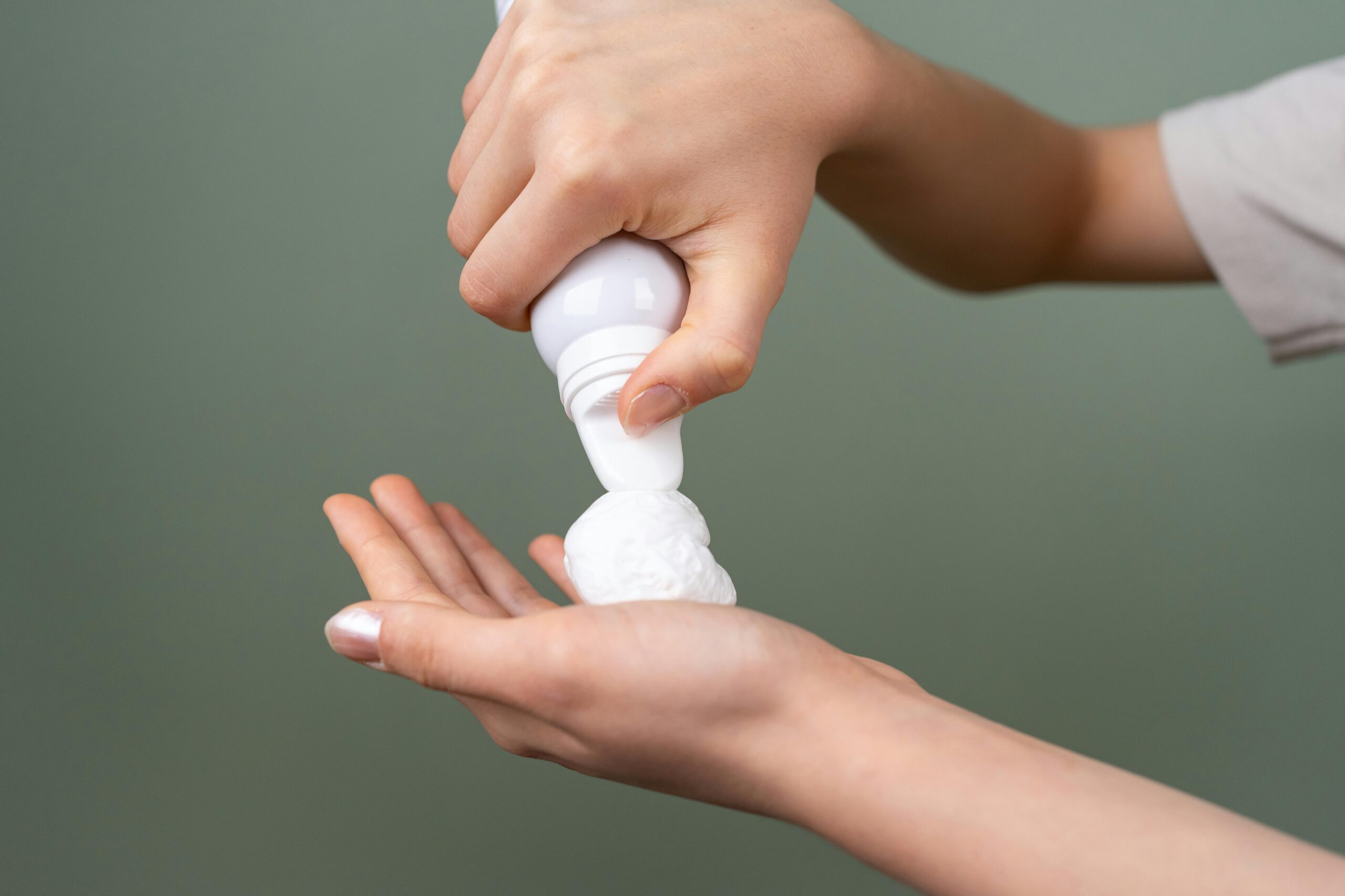 Preparing shaving foam from dispenser for grooming close-up.